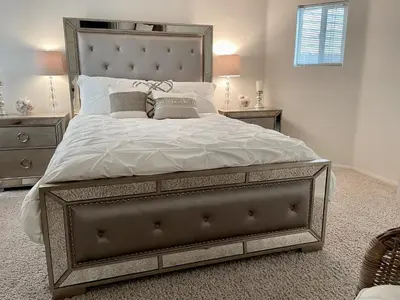 a bedroom with a large bed with white sheets and pillows at Luxury, Beach House, and quiet neighborhood in Oxnard
