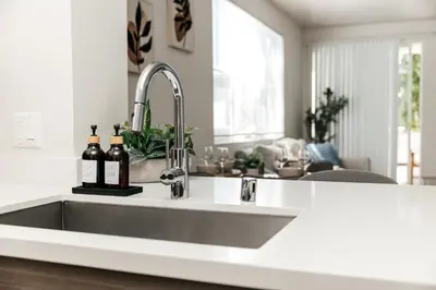 a kitchen sink with two bottles of wine on it at Pearl 2B apartment in Marina with parking, Pool and Gym in Los Angeles