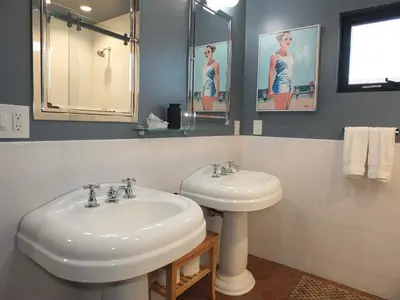 a bathroom with a sink and a mirror at Naples Luxury Retreat - 3 BDR Stay for 6 w Rooftop Patio in Long Beach