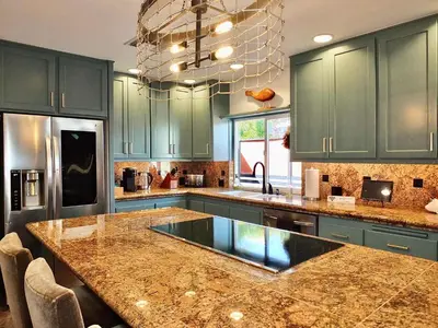 a kitchen with green cabinets and a granite counter top at Naples Luxury Retreat - 3 BDR Stay for 6 w Rooftop Patio in Long Beach
