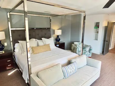 a bedroom with a canopy bed and a couch at Naples Luxury Retreat - 3 BDR Stay for 6 w Rooftop Patio in Long Beach