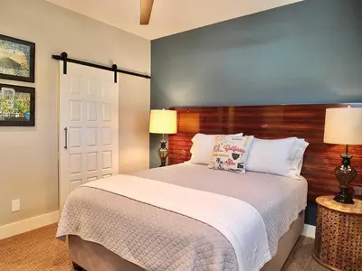 a bedroom with a large bed and two lamps at Naples Luxury Retreat - 2 BDR Walk to Beach Dining & Shops in Long Beach