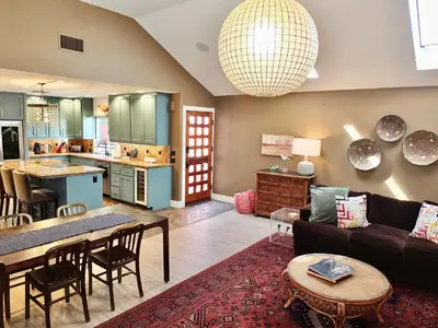 a living room with a couch and a table at Naples Luxury Retreat - 2 BDR Walk to Beach Dining & Shops in Long Beach