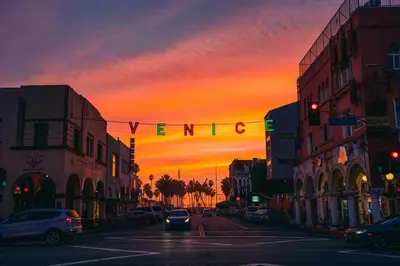 a city street at sunset with a sign that reads vanguard at Beautiful Venice Beach in Los Angeles