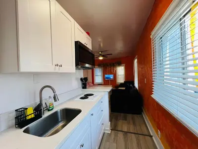 a kitchen with white cabinets and a sink at Beautiful Venice Beach in Los Angeles