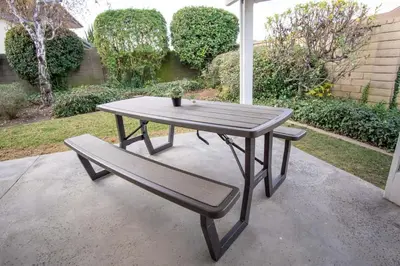 a picnic table and a bench on a patio at CA2 House SoCal Oasis Newly Renovated Game Room in La Palma