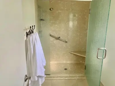a bathroom with a shower with a white towel at CA3 House Spacious SoCal Home for Groups in La Palma