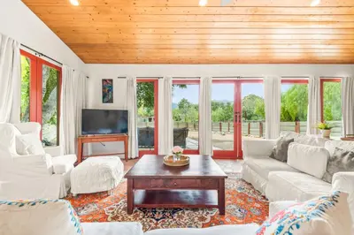 a living room with a couch and a table at Cornell Canyon Getaway in Agoura Hills
