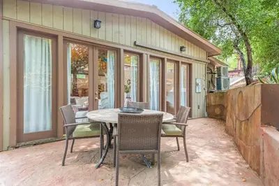 a patio with a table and chairs in front of a house at Cornell Canyon Getaway in Agoura Hills