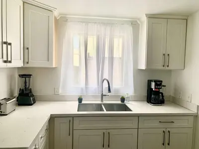 a white kitchen with a sink and a window at CA5 House Cozy 3BR in Azusa in Azusa