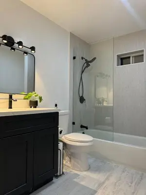 a bathroom with a toilet and a sink and a shower at Lakefront Oasis in Fawnskin