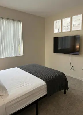 a bedroom with a bed and a flat screen tv at Marina Del Rey View 1BA & 2BA in MDR - Pool, Jacuzzi, Gym in Los Angeles