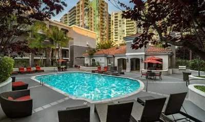 a swimming pool with chairs and a building at Marina del Rey 1BA & 2BA Getaway - Pool - Spa - Gym in Los Angeles