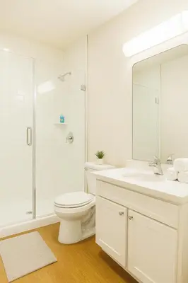 a white bathroom with a toilet and a sink at Marina del Rey 1BA & 2BA Getaway - Pool - Spa - Gym in Los Angeles
