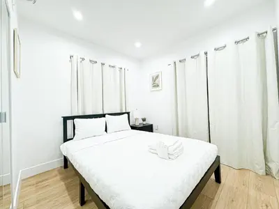 a white bedroom with a large bed with white sheets at Relaxing 2BR Escape in Trendy West LA - CM-CAL in Calabasas