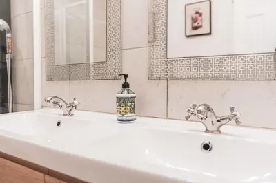 a bathroom with a sink with two faucets at Modern & Airy Silver Lake 2bedroom 2 bath Front House in Los Angeles