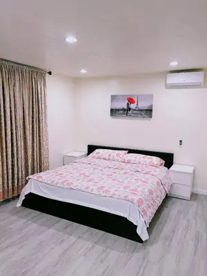a bedroom with a bed and a red umbrella at Hacienda New Remodeled 17miles-Disney in Hacienda Heights