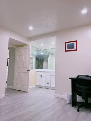 a white bathroom with a desk and a mirror at Hacienda New Remodeled 17miles-Disney in Hacienda Heights