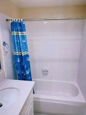 a white bathroom with a tub and a sink at Hacienda New Remodeled 17miles-Disney in Hacienda Heights