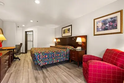 a hotel room with a bed and a desk and a couch at Paradise Lodge - Canoga Park, Los Angeles in Winnetka