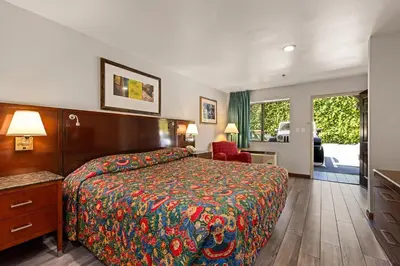 a hotel room with a bed with a colorful bedspread at Paradise Lodge - Canoga Park, Los Angeles in Winnetka