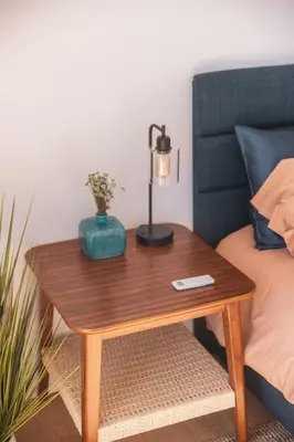 a table with a lamp on it next to a bed at Industrial&Stylish 3 bedroom 3 bathrooms Home With Views and Hot tub in Los Angeles
