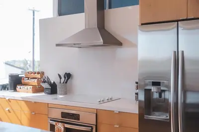 a kitchen with a stainless steel refrigerator and a stove at Industrial&Stylish 3 bedroom 3 bathrooms Home With Views and Hot tub in Los Angeles