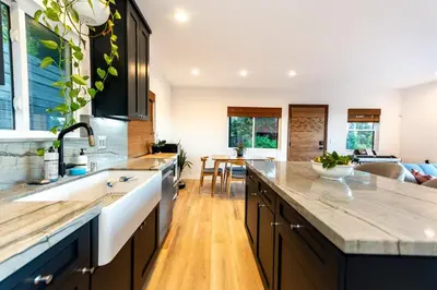 a kitchen with a large counter and a living room at Hidden Oasis 3 bedroom 2 bathroom Home With large backyard and Views Near DTLA in Los Angeles