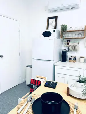 a kitchen with a table with a black plate on it at Welcoming Claremont Studio With Private Yard and Pool Spa in Claremont