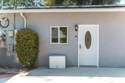 a house with a white door and a window at Welcoming Claremont Studio With Private Yard and Pool Spa in Claremont