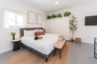 a bedroom with a large bed and a tv at Welcoming Claremont Studio With Private Yard and Pool Spa in Claremont