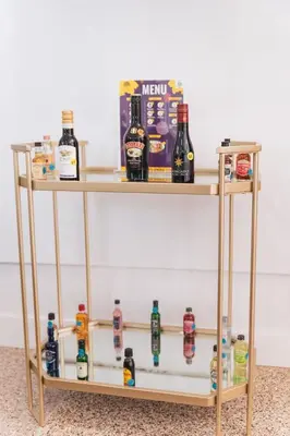 a wooden shelf with bottles of alcohol on it at Renovated Stylish Guesthouse By Claremont With Private Patio in Montclair