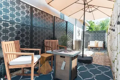 a patio with two chairs and an umbrella at Renovated Stylish Guesthouse By Claremont With Private Patio in Montclair