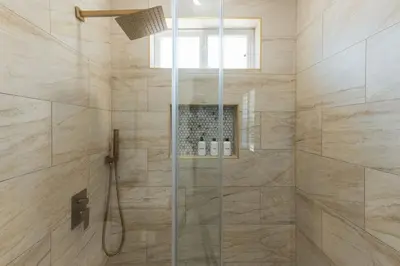 a bathroom with a shower with a glass door at Renovated Stylish Guesthouse By Claremont With Private Patio in Montclair