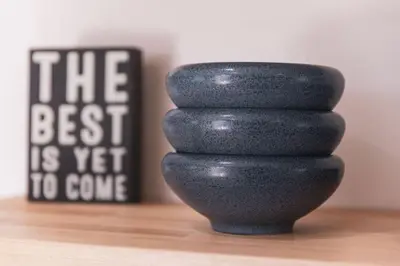 a stack of black rocks sitting on a wooden table at Renovated Stylish Guesthouse By Claremont With Private Patio in Montclair