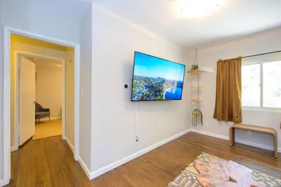 a living room with a flat screen tv on a wall at Charming and Cozy 1 Bedroom 1 Bathroom Guest Suite in Silverlake in Los Angeles
