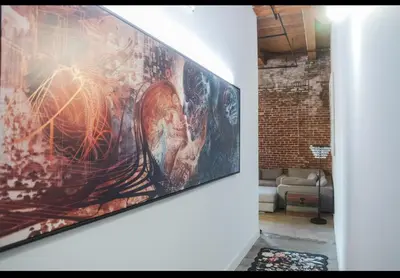 a painting hanging on a wall in a living room at 1400 square foot Arts District Warehouse Loft 1 bedroom 1 bathroom in Los Angeles