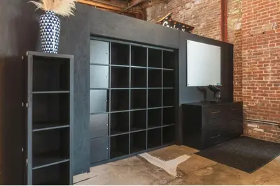 a room with a black wall with a television at 1400 square foot Arts District Warehouse Loft 1 bedroom 1 bathroom in Los Angeles