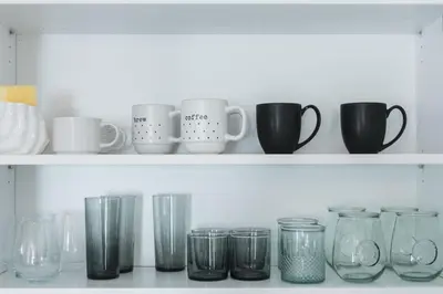 a row of glasses and mugs on a shelf at Renovated 1 Bedroom 1 bathroom Cottage Near Larchmont Village in Los Angeles
