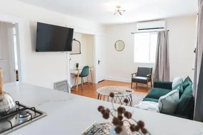 a living room with a couch and a table at Renovated 1 Bedroom 1 bathroom Cottage Near Larchmont Village in Los Angeles
