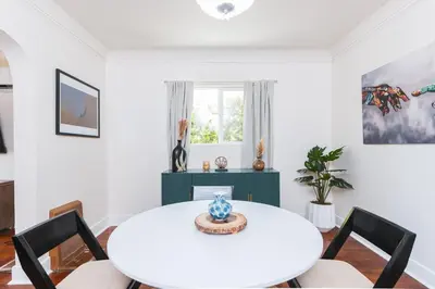 a white dining room with a white table and chairs at Charming Vintage 2 bedroom 1 Bathroom Close to Larchmont Village in Los Angeles