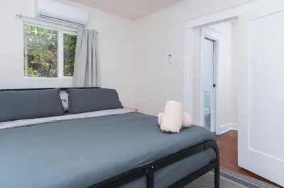 a bedroom with a large bed with a window at Charming Vintage 2 bedroom 1 Bathroom Close to Larchmont Village in Los Angeles