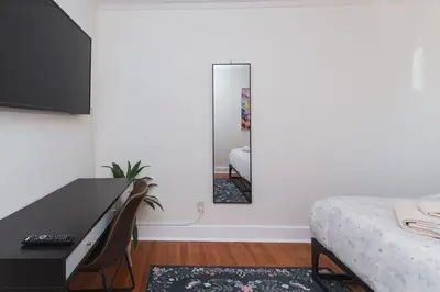a bedroom with a desk and a mirror and a bed at Quaint Updated 2 bedroom 1 bathroom Cottage Near Larchmont Village in Los Angeles