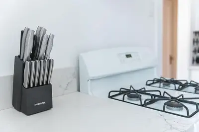 a knife block sitting on a counter next to a stove at Quaint Updated 2 bedroom 1 bathroom Cottage Near Larchmont Village in Los Angeles