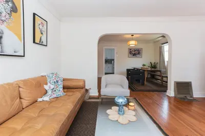 a living room with a couch and a table at Quaint Updated 2 bedroom 1 bathroom Cottage Near Larchmont Village in Los Angeles