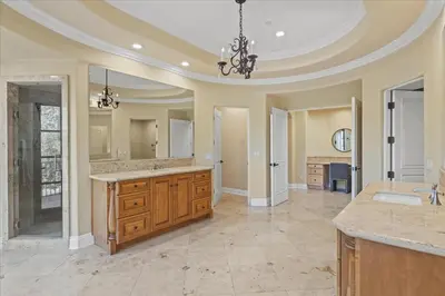 a large bathroom with a sink and a large mirror at 5800 sq ft Gorgeous Tarzana 7 bedroom 9 bathroom home with pool and hot tub in Tarzana