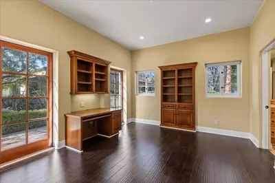 an empty home office with a desk and windows at 5800 sq ft Gorgeous Tarzana 7 bedroom 9 bathroom home with pool and hot tub in Tarzana