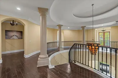 a lobby with a staircase with columns and a chandelier at 5800 sq ft Gorgeous Tarzana 7 bedroom 9 bathroom home with pool and hot tub in Tarzana
