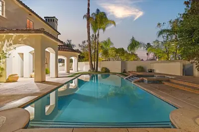 a swimming pool in the backyard of a house at 5800 sq ft Gorgeous Tarzana 7 bedroom 9 bathroom home with pool and hot tub in Tarzana