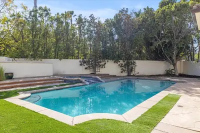 a swimming pool in the yard of a house at 5800 sq ft Gorgeous Tarzana 7 bedroom 9 bathroom home with pool and hot tub in Tarzana